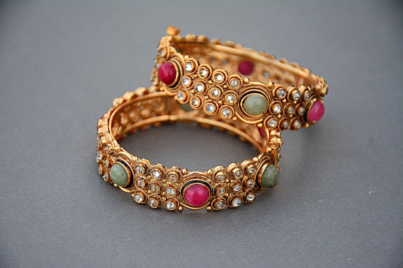 Gold bangles set with gemstones