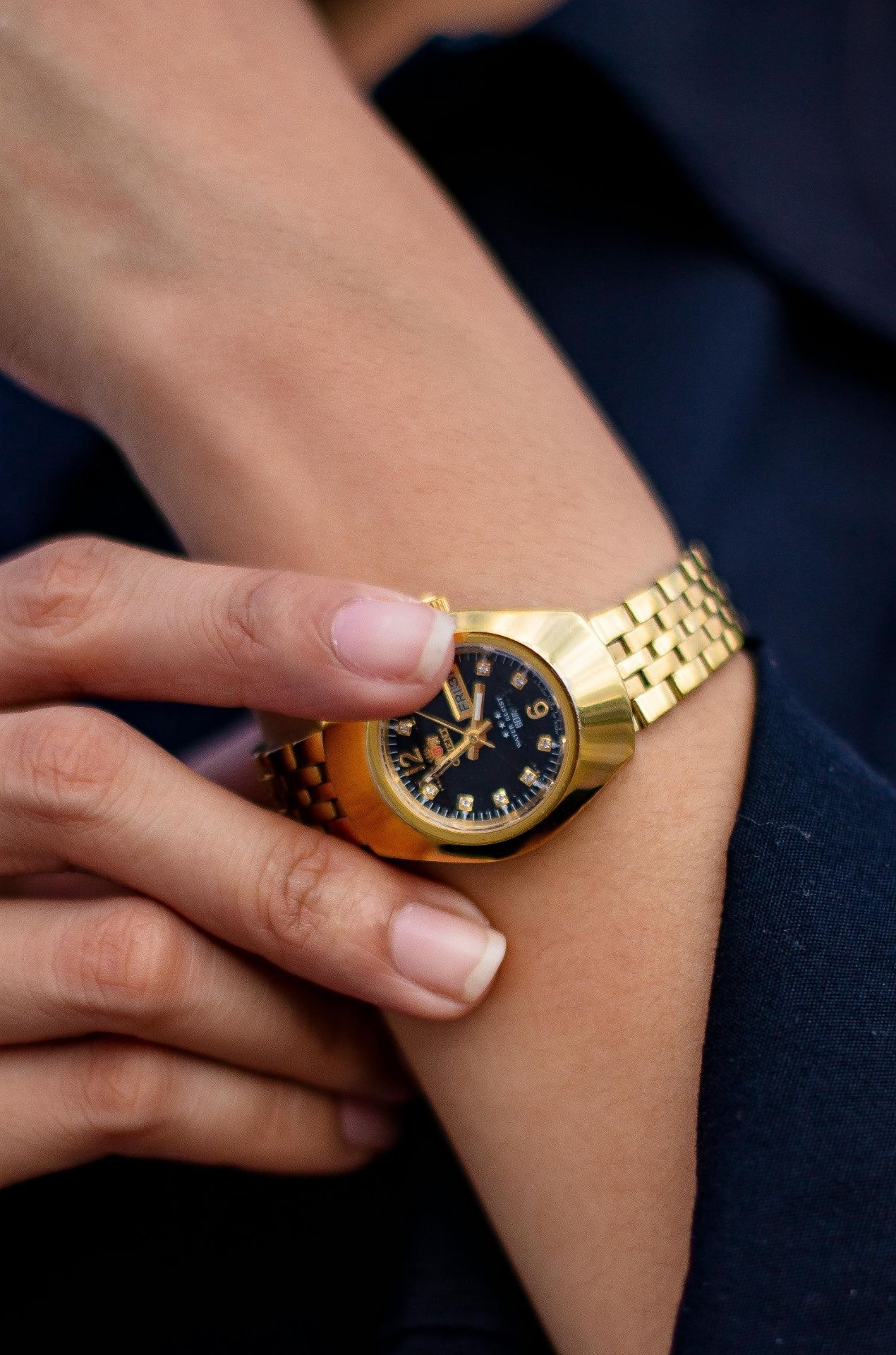 Gold watch on a wrist